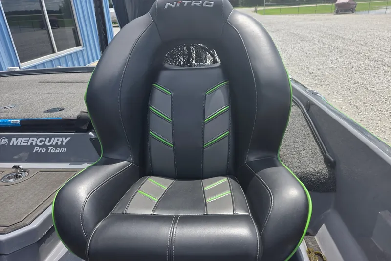 Slide: The Image of 2023 Nitro Z21 XL boat seat with black and green accents, featuring Mercury Pro Team branding. - 11