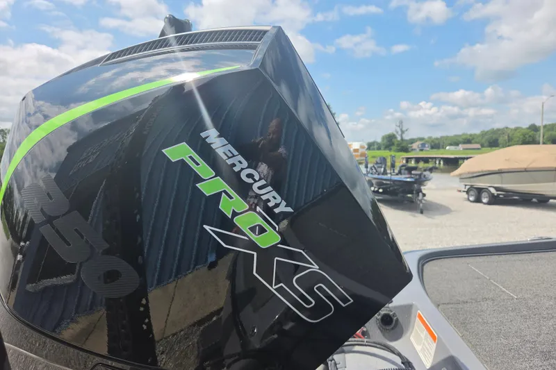 Slide: The Image of 2023 Nitro Z21 XL with Mercury Pro XS engine, parked outdoors under a blue sky. - 13