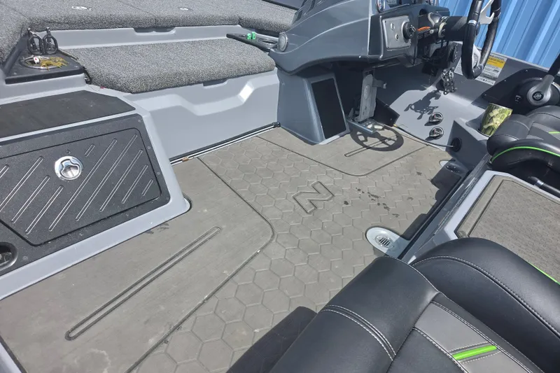 Slide: The Image of 2023 Nitro Z21 XL boat interior with gray flooring and black seating. - 9