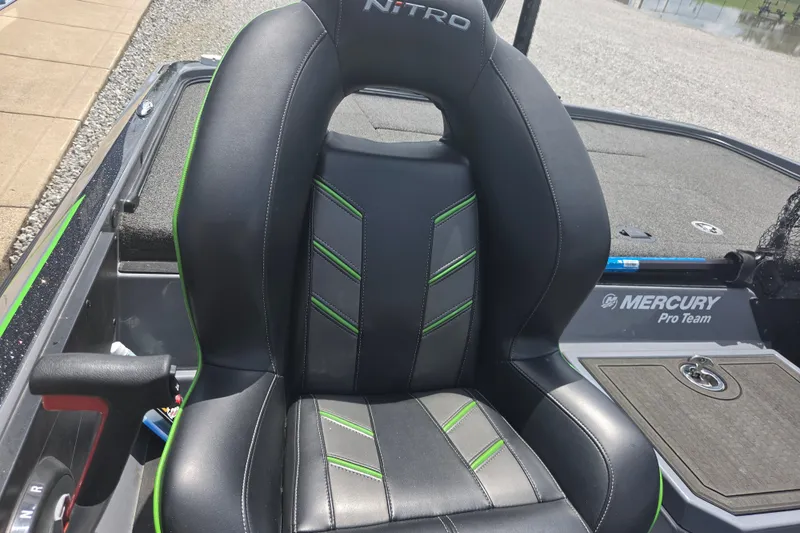 Slide: The Image of 2023 Nitro Z21 XL boat seat with black and green accents, Mercury Pro Team branding. - 10