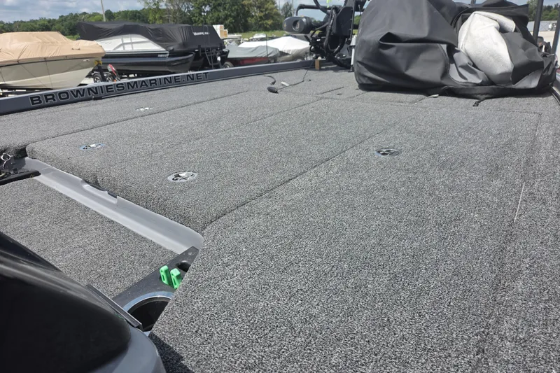 Slide: The Image of 2023 Nitro Z21 XL boat deck with gray carpet, parked among other boats. - 6