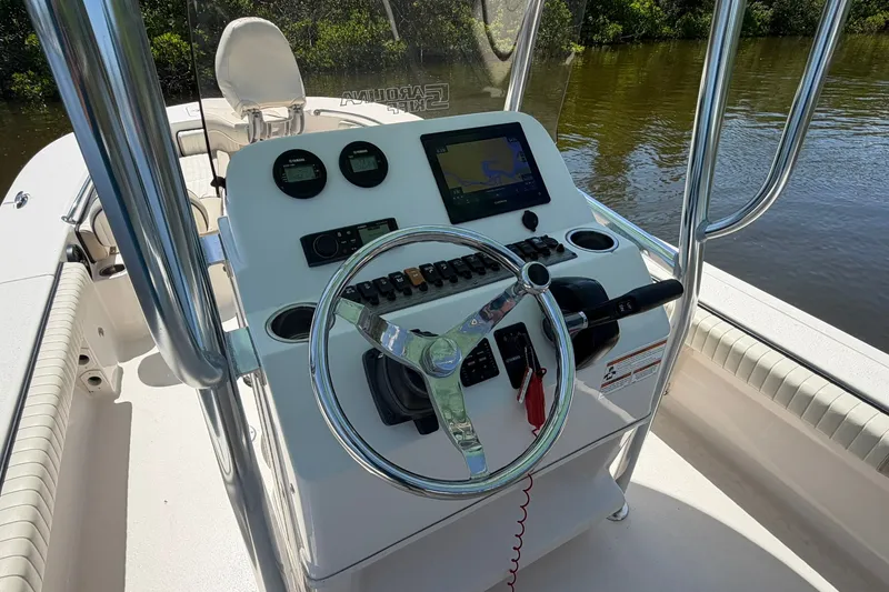 Slide: The Image of 2022 Carolina Skiff 26 Ultra Elite boat console with steering wheel and navigation controls. - 19