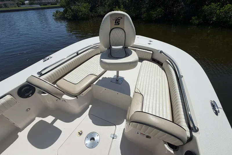Slide: The Image of 2022 Carolina Skiff 26 Ultra Elite boat interior with cushioned seating and steering wheel. - 24