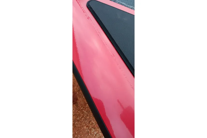 Slide: The Image of Close-up of 2027 Tracker Pro Team 175 boat's red exterior detail. - 13