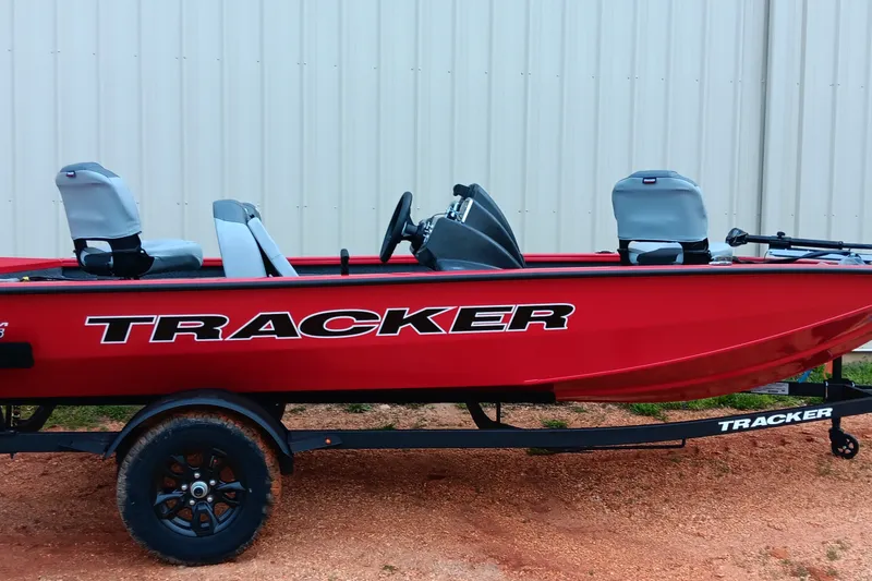 The Image of Red 2027 Tracker Pro Team 175 boat on trailer, parked outdoors. - 0