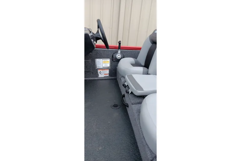 Slide: The Image of Interior of 2027 Tracker Pro Team 175 boat with steering wheel and seats. - 15