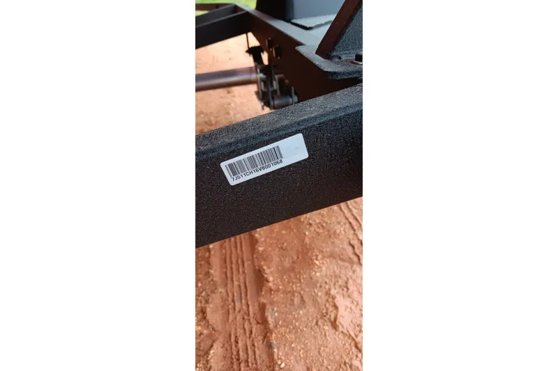 Slide: The Image of Barcode on Tracker Pro Team 175 boat trailer, 2027 model, on dirt ground. - 19