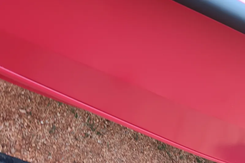 Slide: The Image of Red Tracker Pro Team 175 boat, 2027 model, on gravel surface. - 14