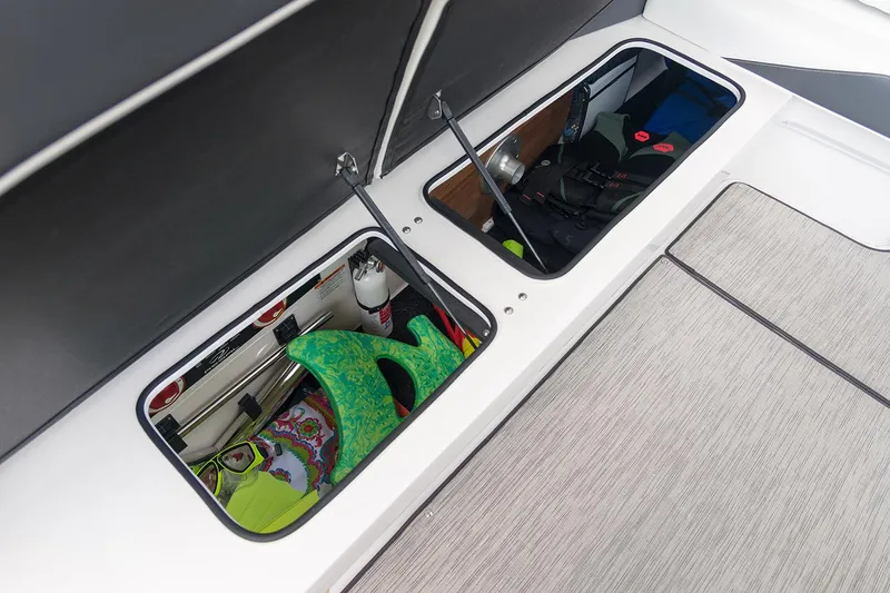 Slide: The Image of Manufacturer Provided Image: 2026 Regal 3300 boat storage compartments with safety gear and accessories. - 15