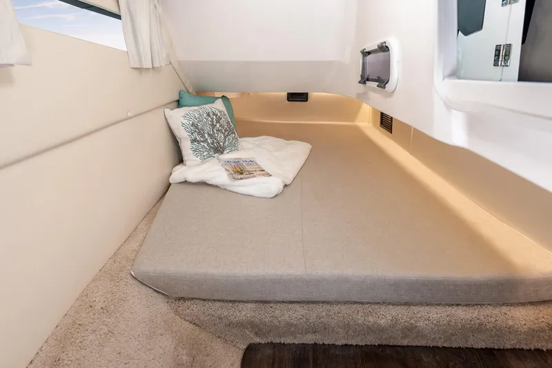 Slide: The Image of Manufacturer Provided Image: Cozy cabin interior of 2026 Regal 3300 boat with comfortable bedding and decor. - 16
