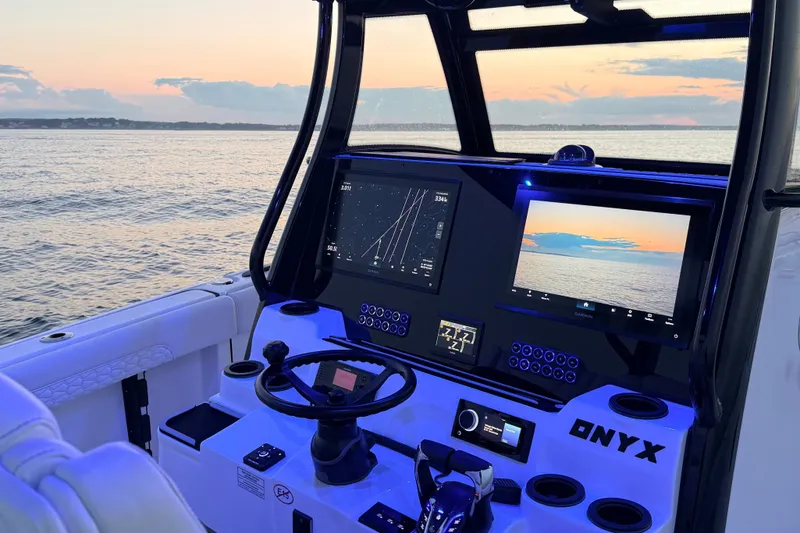 Slide: The Image of The cockpit of the Tidewater 330 CC Adventure features modern navigation screens at sunset. - 24