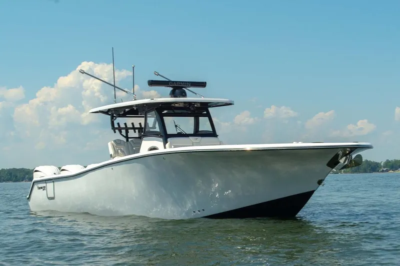 Slide: The Image of Manufacturer Provided Image: 2027 Tidewater 330 CC Adventure boat on calm water under blue sky. - 3