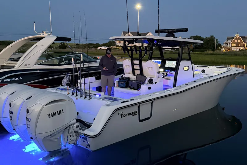 Slide: The Image of A modern Tidewater 330 CC Adventure with glowing blue lights and twin Yamaha engines. - 28