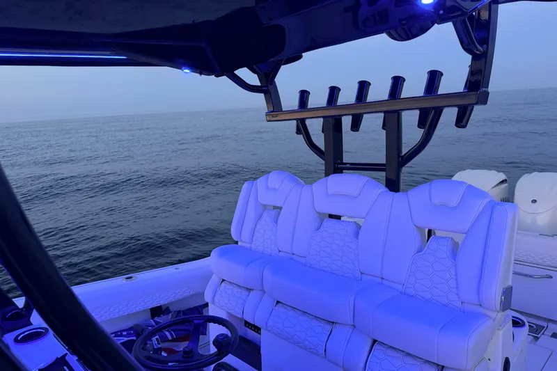Slide: The Image of 2027 Tidewater 330 CC Adventure boat interior with illuminated seating and ocean view. - 19