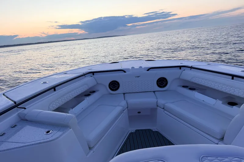 Slide: The Image of 2027 Tidewater 330 CC Adventure boat interior at sunset on the water. - 18