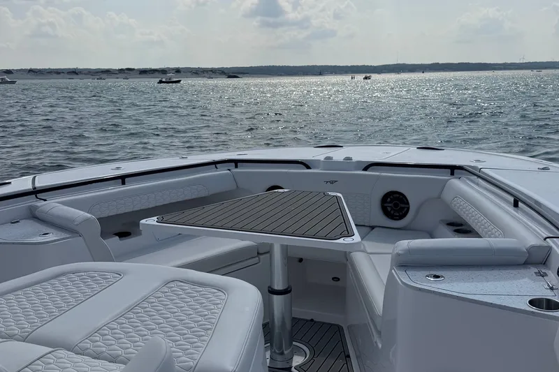 Slide: The Image of The image shows the cockpit of a 2027 Tidewater 330 CC Adventure boat on the water. - 29