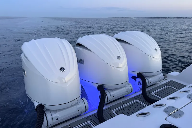 Slide: The Image of Triple Yamaha outboard engines on 2027 Tidewater 330 CC Adventure boat at sea. - 26