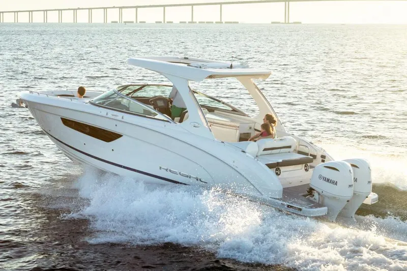 The Image of Manufacturer Provided Image: 2026 Regal 33 OBX boat cruising on open water with bridge in background. - 1