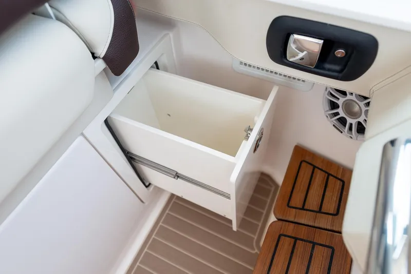 Slide: The Image of Manufacturer Provided Image: 2026 Regal LS36 boat interior with open storage drawer and speaker. - 17