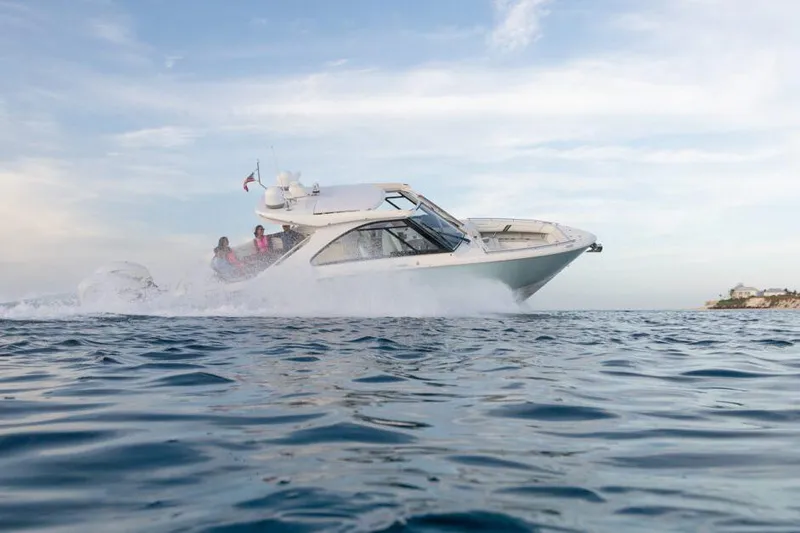 Slide: The Image of Manufacturer Provided Image: 2026 Regal LX36 boat cruising on open water under a clear sky. - 0