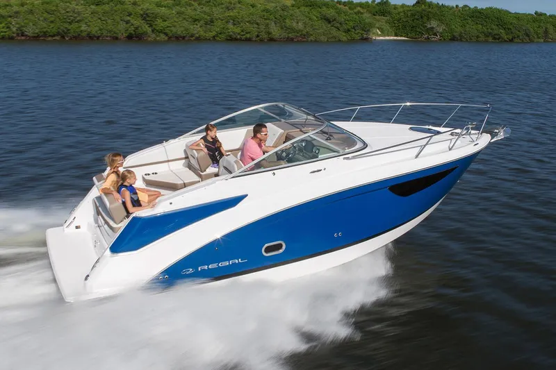 The Image of Manufacturer Provided Image: 2026 Regal 26 Express boat cruising on water with passengers, featuring sleek blue and white design. - 0