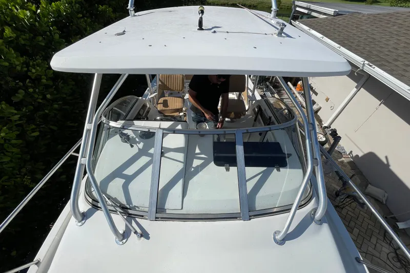 Slide: The Image of 2001 Hydra-Sports Vector 2800 WA boat with person on deck, surrounded by greenery. - 26