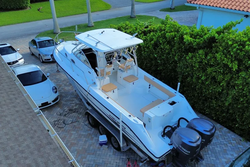 Slide: The Image of 2001 Hydra-Sports Vector 2800 WA boat on trailer, parked beside luxury cars. - 45