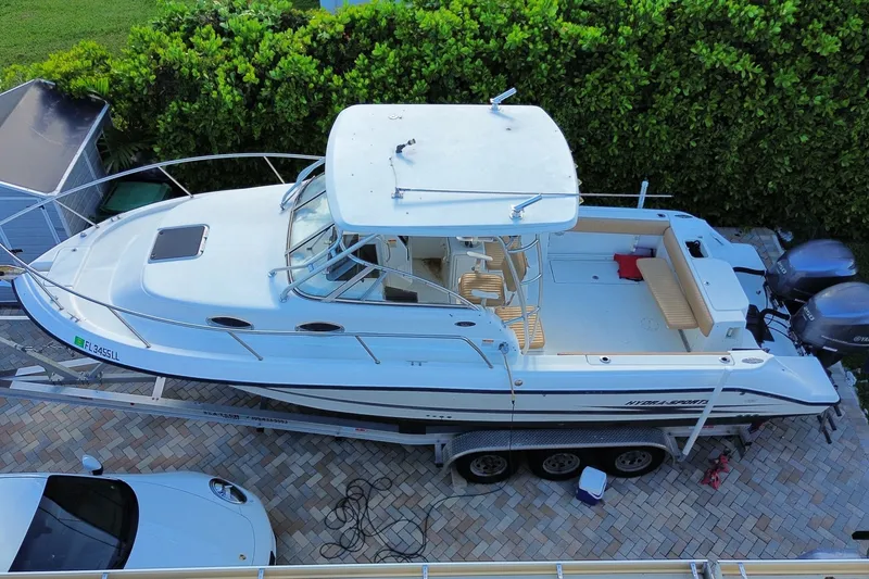 Slide: The Image of 2001 Hydra-Sports Vector 2800 WA boat on trailer, parked on brick driveway. - 46