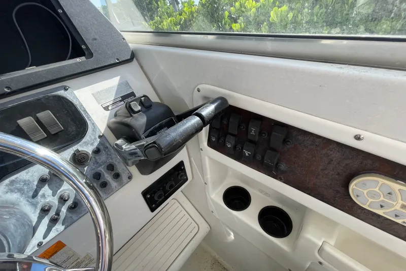 Slide: The Image of 2001 Hydra-Sports Vector 2800 WA boat dashboard with steering wheel and control panel. - 36