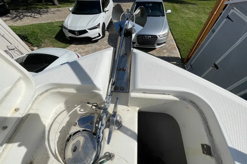 Slide: The Image of 2001 Hydra-Sports Vector 2800 WA boat anchor system with parked cars in background. - 25