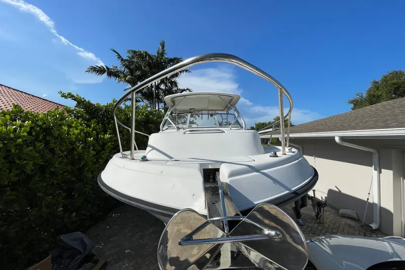 Slide: The Image of 2001 Hydra-Sports Vector 2800 WA boat parked near greenery and house. - 16