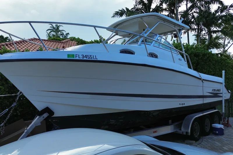 The Image of 2001 Hydra-Sports Vector 2800 WA boat on trailer, surrounded by tropical foliage. - 0