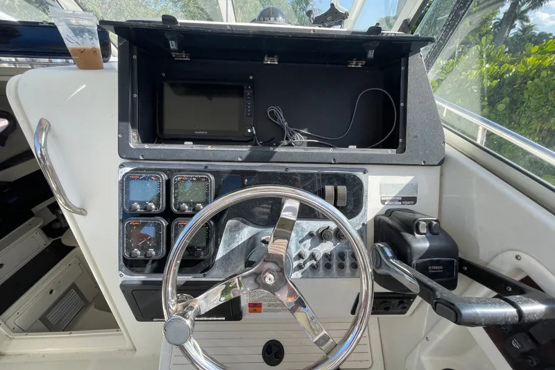 Slide: The Image of Helm of 2001 Hydra-Sports Vector 2800 WA with steering wheel and navigation instruments. - 35