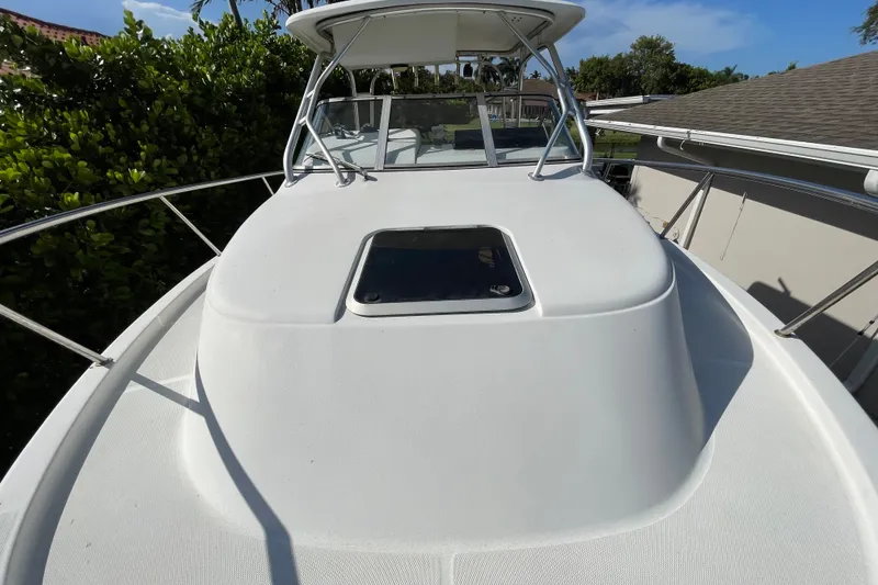 Slide: The Image of 2001 Hydra-Sports Vector 2800 WA boat deck with hatch, surrounded by lush greenery. - 24
