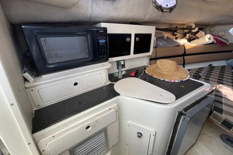 Slide: The Image of 2001 Hydra-Sports Vector 2800 WA cabin with kitchenette, microwave, and storage. - 38
