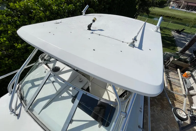 Slide: The Image of 2001 Hydra-Sports Vector 2800 WA boat with white hardtop and windshield, docked outdoors. - 29
