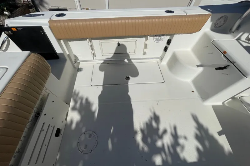 Slide: The Image of 2001 Hydra-Sports Vector 2800 WA boat interior with tan seating and storage compartments. - 19