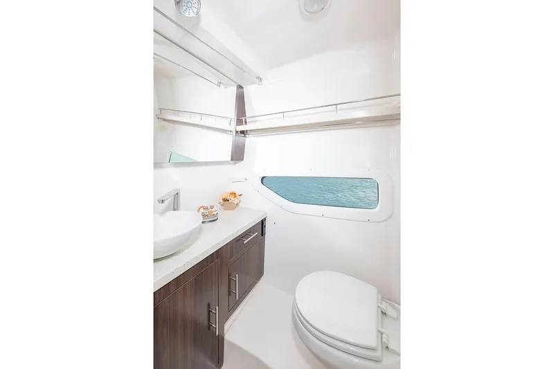 Slide: The Image of Manufacturer Provided Image: 2026 Regal 33 XO yacht bathroom with modern fixtures and ocean view window. - 18