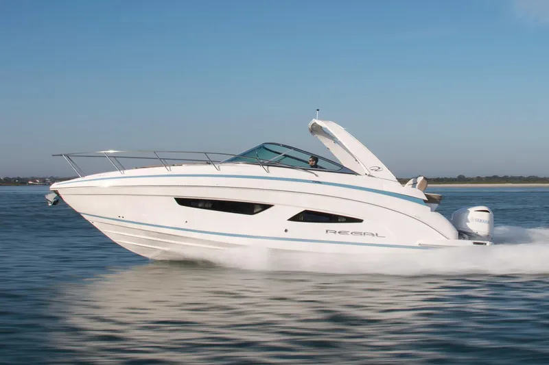 The Image of Manufacturer Provided Image: 2026 Regal 33 XO boat cruising on calm water under clear blue sky. - 0