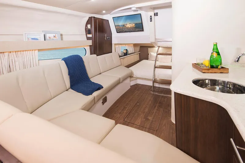 Slide: The Image of Manufacturer Provided Image: Luxurious interior of 2026 Regal 33 XO yacht with modern seating and kitchenette. - 15