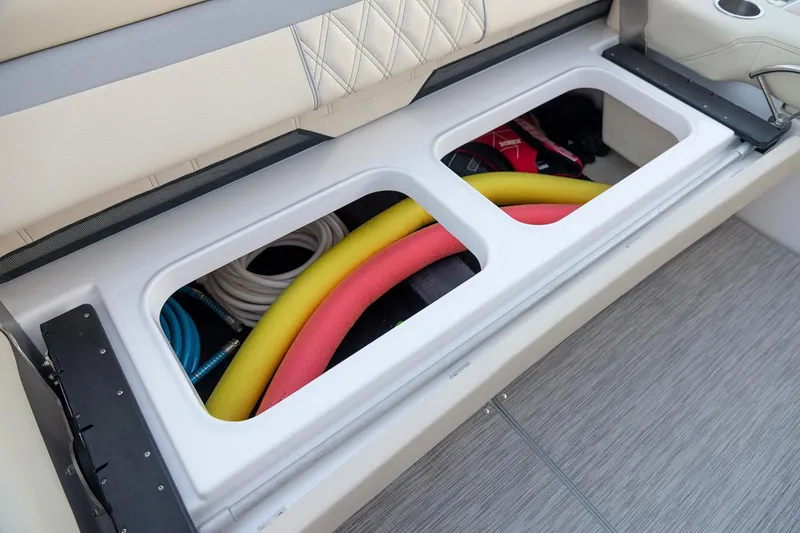 Slide: The Image of Manufacturer Provided Image: Storage compartment on a 2026 Regal 33 XO boat with colorful equipment. - 14