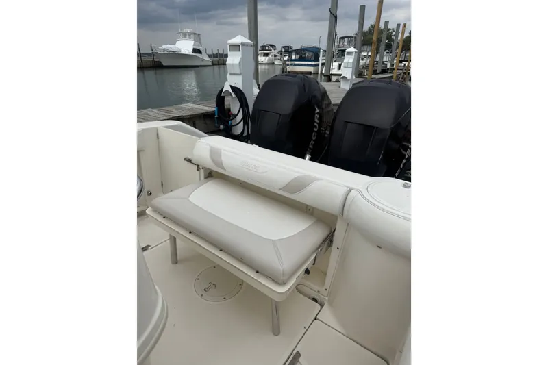 Slide: The Image of 2005 Boston Whaler 270 Outrage boat interior with seating and dual Mercury engines. - 16