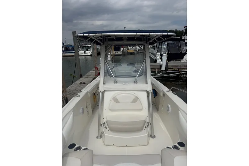 Slide: The Image of 2005 Boston Whaler 270 Outrage boat docked at marina under cloudy sky. - 10
