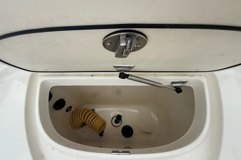 Slide: The Image of Open storage compartment on a 2005 Boston Whaler 270 Outrage boat. - 19