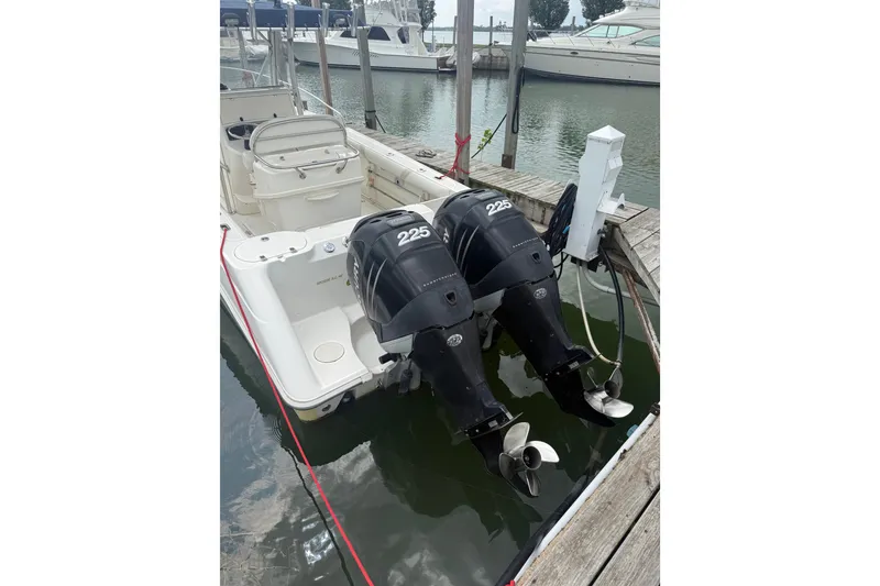 Slide: The Image of 2005 Boston Whaler 270 Outrage with twin 225 horsepower engines docked at marina. - 2