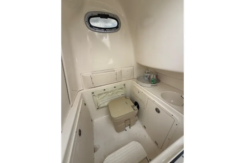 Slide: The Image of 2005 Boston Whaler 270 Outrage boat interior with compact bathroom amenities. - 17