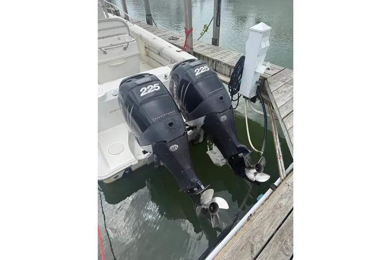 Slide: The Image of Twin 225 horsepower engines on a 2005 Boston Whaler 270 Outrage at dock. - 3