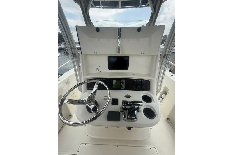 Slide: The Image of Helm of 2005 Boston Whaler 270 Outrage with steering wheel and controls. - 13