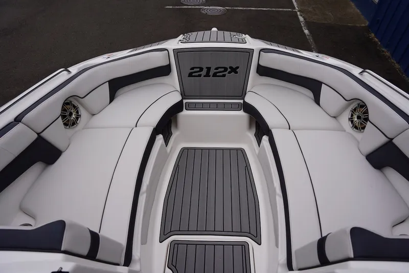 Slide: The Image of Interior view of a 2014 Yamaha Boats 212X, featuring sleek white seating and modern design. - 5