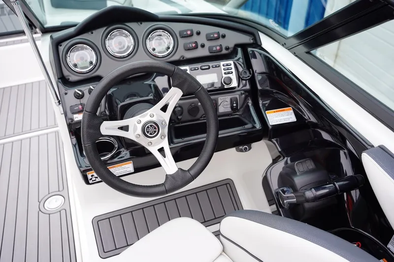 Slide: The Image of 2014 Yamaha Boats 212X dashboard with steering wheel and control panel. - 6